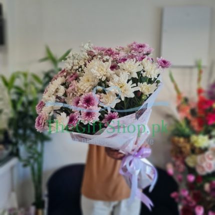 A bouquet of pink and white chrysanthemums with baby’s breath
