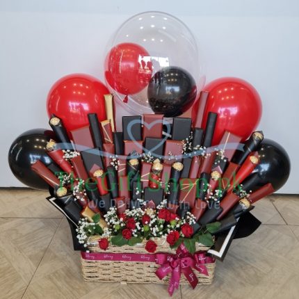 Chocolate Fiesta Basket. A gift basket with 60 assorted chocolates, fresh flowers and colorful balloons