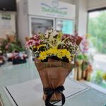 A floral arrangement of mixed chrysanthemums, lilies and gypso in various colors, in a flower foam