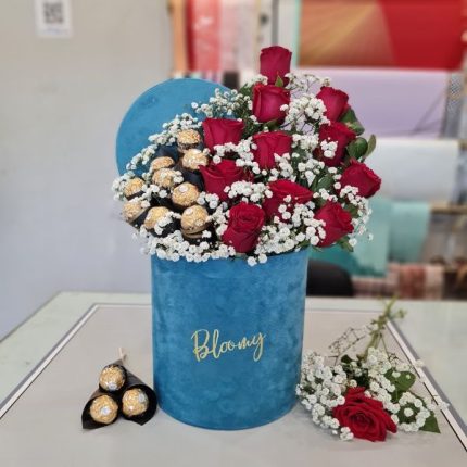 A flower box of red roses and baby’s breath with Ferrero Rocher chocolates