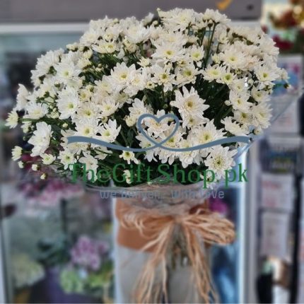 A bouquet of 20 white chrysanthemums wrapped in white paper and tied with a white ribbon