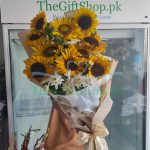 A bouquet of yellow sunflowers with green leaves and white filler flowers