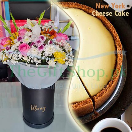 Cheesy Blooms : A photo of a gift set that consists of a slice of New York cheesecake and a bouquet of flowers in a black box
