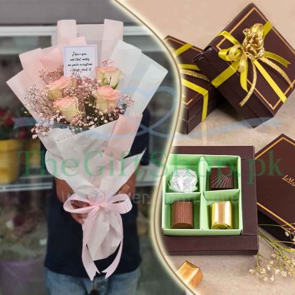 A gift set consisting of a bouquet of pink roses and white baby’s breath wrapped in pink paper and ribbon, and a box of assorted chocolates with a gold ribbon and bow on top.