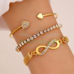 Three gold color bracelets with Chrystal, heart and infinity charms