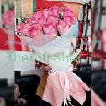 A serene bouquet of pink roses with baby’s breath,