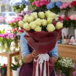 20 White Long Stem Roses. Estate White features premium ivory roses in a luxury burgundy wrap. Fast, fresh flower delivery service in Pakistan.